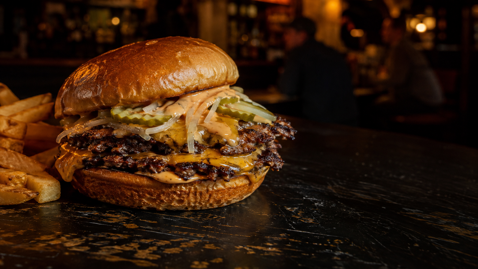 Double smash cheeseburger with pickles, onions, house sauce, and crispy fries