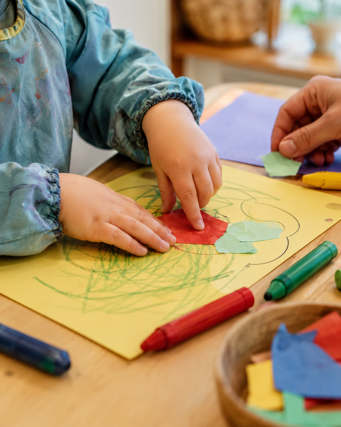 Young child creating artwork with colorful craft materials